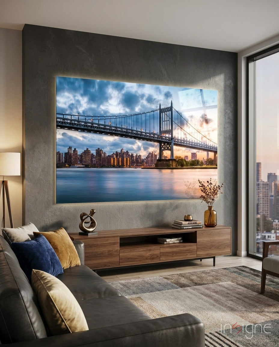 Illuminated glass wall art displaying Queensboro Bridge at sunset with Manhattan skyline, installed above wooden media console in modern living room.
