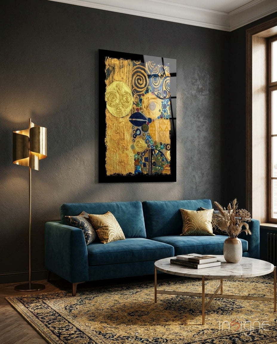 Gold and blue abstract glass wall art with circular and spiral patterns displayed above a teal sofa in a modern living room.