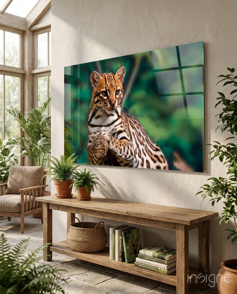 Cheetah glass wall art displaying a spotted wild cat against green blurred background, mounted in bright room with plants and wooden furniture.