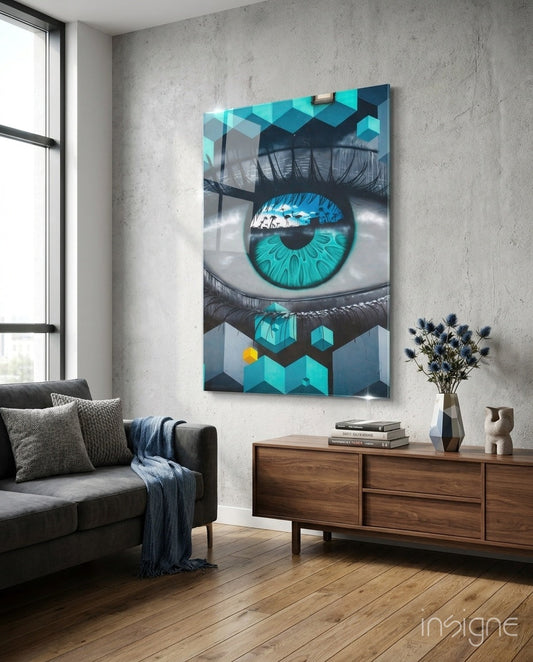 Turquoise eye glass wall art displayed above wooden dresser in modern living room with grey sofa and concrete walls.