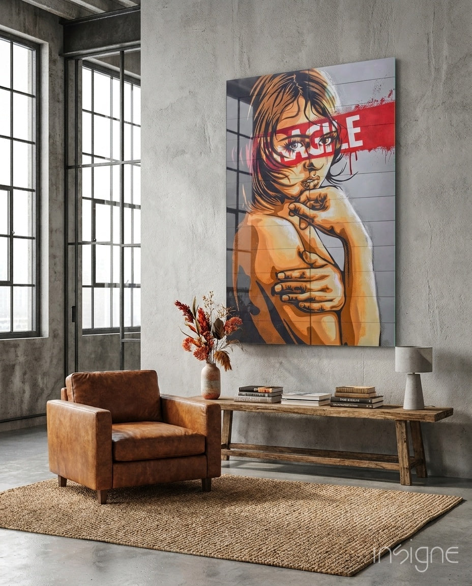 Large glass wall art featuring portrait of child with red stripe across eyes, displayed in industrial loft room above wooden console table.