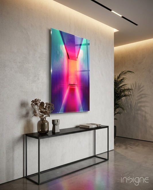 Vibrant neon glass wall art with pink, purple, and turquoise geometric shapes displayed above a black metal console table in a modern interior.