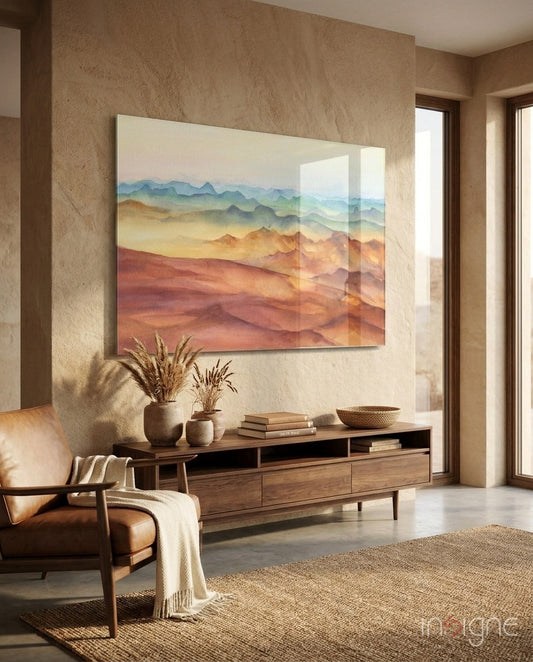 Abstract layered mountain landscape in warm earth tones displayed on beige textured wall above wooden media console in modern living room.