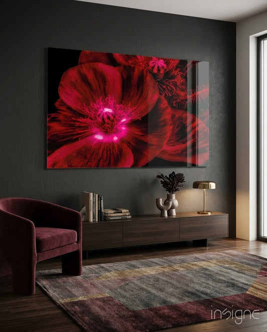Crimson Poppy glass wall art displayed above a wooden console in a modern interior with burgundy chair and patterned rug.
