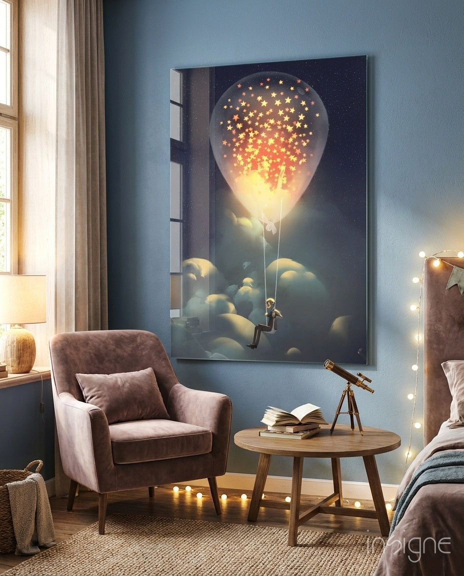 Starry Dream Glass Wall Art displayed above a mauve armchair in a bedroom setting, showing a silhouetted figure on a glowing hot air balloon releasing golden stars into a night sky.