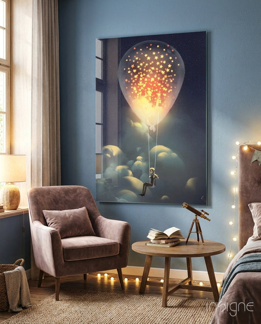 Starry Dream Glass Wall Art displayed above a mauve armchair in a bedroom setting, showing a silhouetted figure on a glowing hot air balloon releasing golden stars into a night sky.