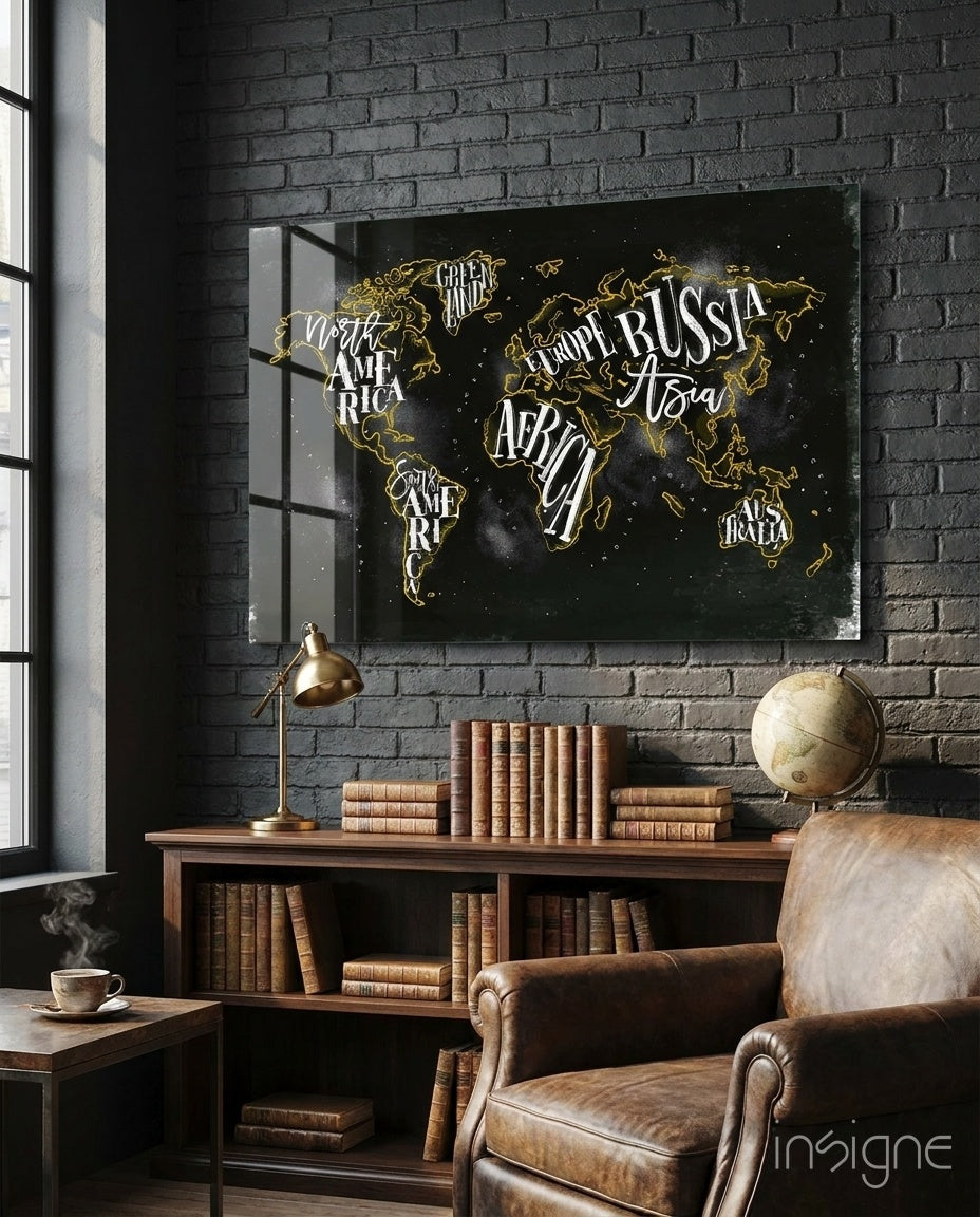 Black canvas world map with gold continent outlines and white continent labels displayed above wooden desk in vintage study room.