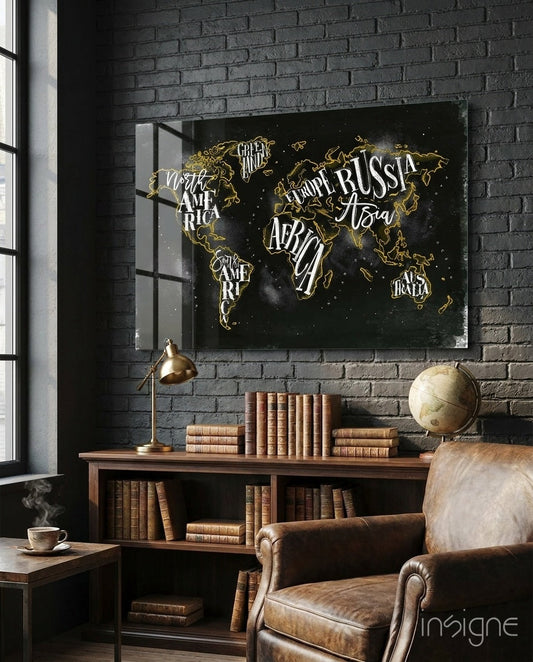 Black canvas world map with gold continent outlines and white continent labels displayed above wooden desk in vintage study room.