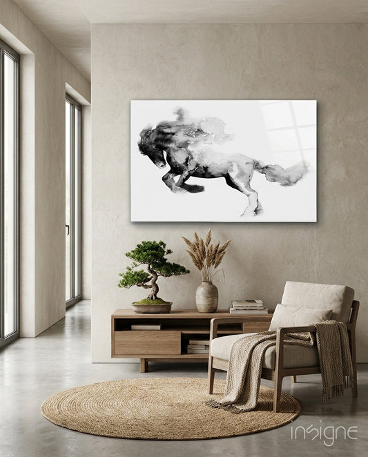 Ink Smoke Galloping Horse glass wall art displayed above a wooden console table in a minimalist interior with beige walls.