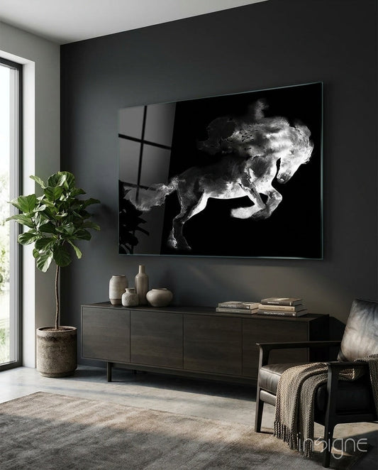 Black and white rearing horse glass wall art displayed above a dark console table in a modern living room with dark walls and natural light from a window.