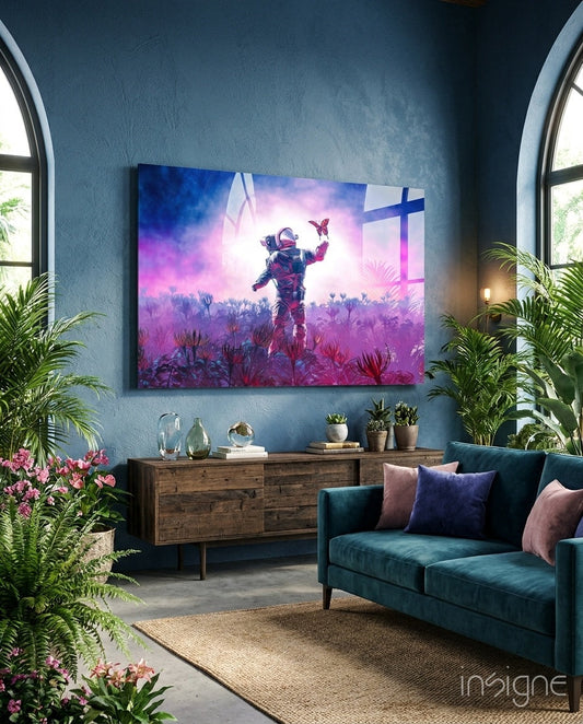 Vibrant glass wall art depicting an astronaut holding a butterfly in a purple alien landscape, displayed above a wooden dresser in a blue-walled room.