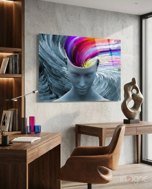 Vibrant glass wall art depicting a blue head with colorful swirling brain design displayed in modern office workspace.