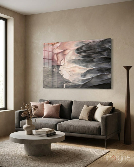 Blush and Charcoal Feather Smoke Glass Wall Art displayed above a gray sofa in a minimalist living room setting.