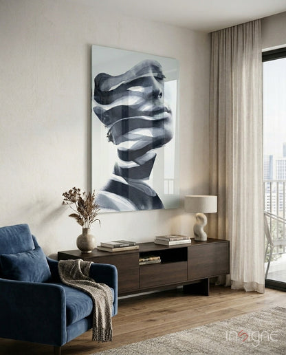 Modern living room interior with black and white glass wall art depicting an abstract fragmented male face above a dark wood console table.