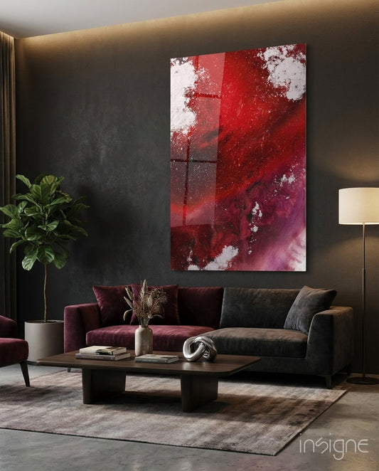 Ruby Magenta Fluid Abstract Glass Wall Art displayed above a burgundy and charcoal sofa in a modern living room interior.