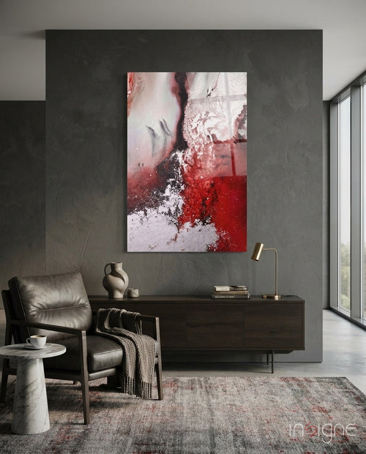 Red and white marble blend glass wall art displayed above a dark wooden dresser in a minimalist interior space.