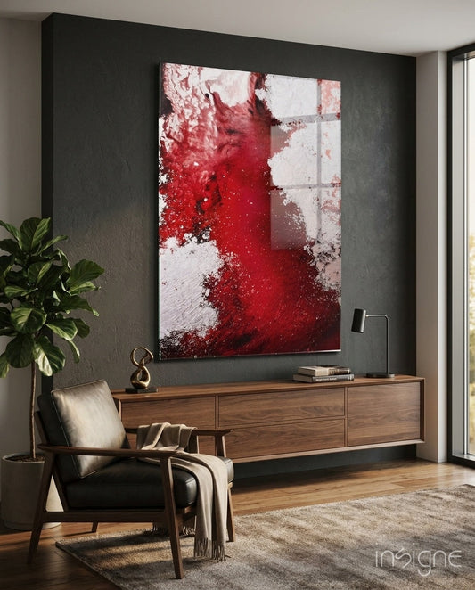 Crimson red ink splash glass wall art displayed above a wooden console in a modern living room with dark gray walls and mid-century furniture.