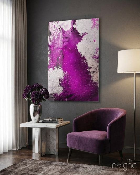 Purple and white abstract glass wall art hanging above a marble side table with purple velvet chair in modern interior setting.