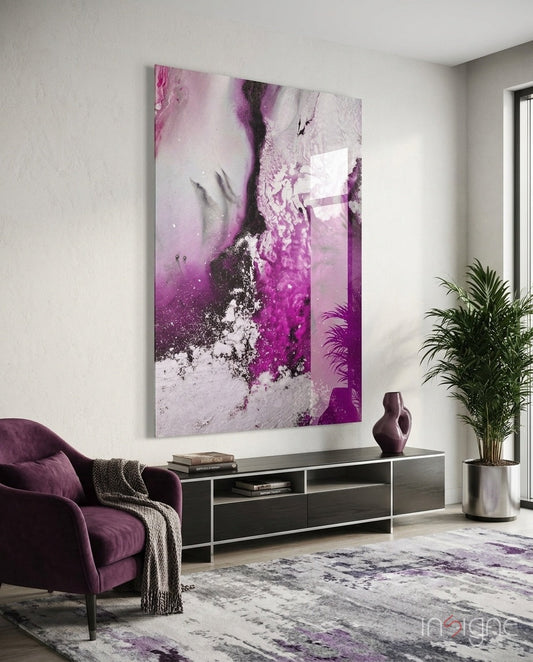 Orchid Pink Marble Flow Glass Wall Art displayed above a dark media console in a modern living room with purple chair and potted plant.