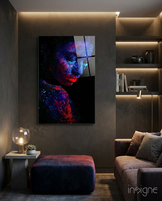 Serenity Glass Wall Art depicting a portrait with red and blue luminescent particles against black background, mounted in modern living room with ambient lighting.