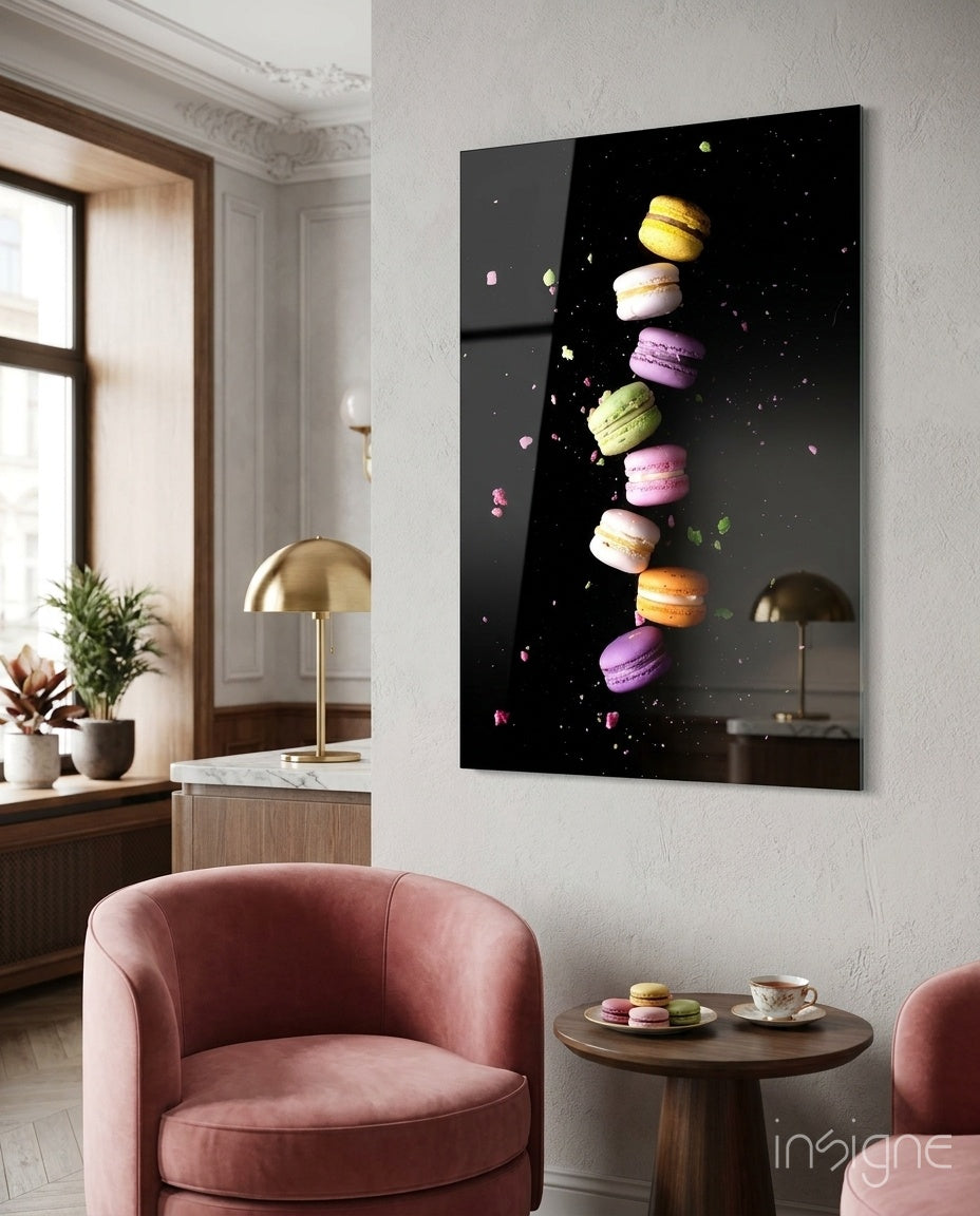 Colorful macarons stacked vertically on black glass wall art displayed above pink velvet chair in elegant living room.