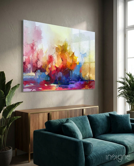 Colorful abstract tree glass art hanging above teal sofa in modern living room with plants and wooden cabinet.