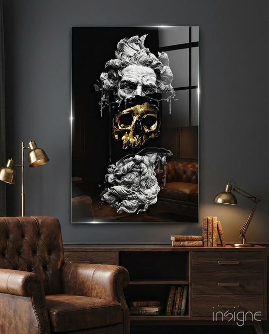 Modern home office interior with illuminated glass wall art displaying white marble busts, gold skull, and classical faces on black background above wooden desk.
