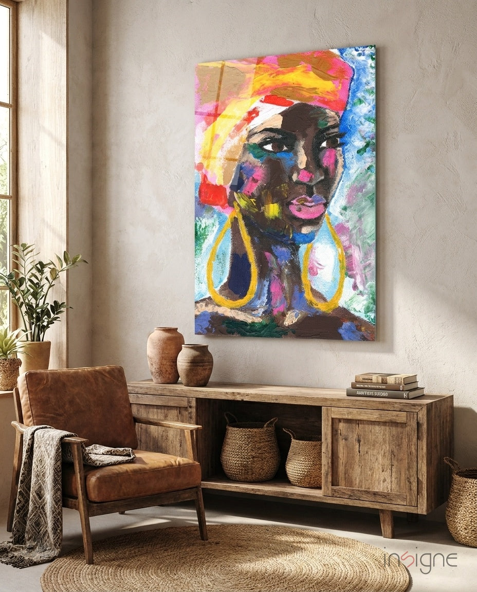 Colorful pop art portrait of a woman with vibrant yellow headwrap and gold earrings displayed above wooden furniture in a styled room interior.