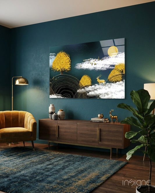 Golden Trees Deer And Clouds Glass Wall Art displayed above wooden dresser in teal-walled living room with brass lamp and mustard chair.