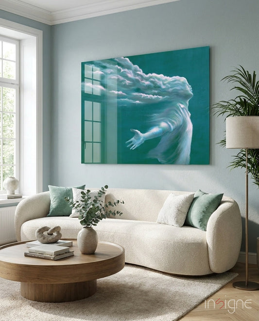 Teal glass wall art depicting a cloud-formed head with an outstretched arm displayed above a cream sofa in a living room setting.