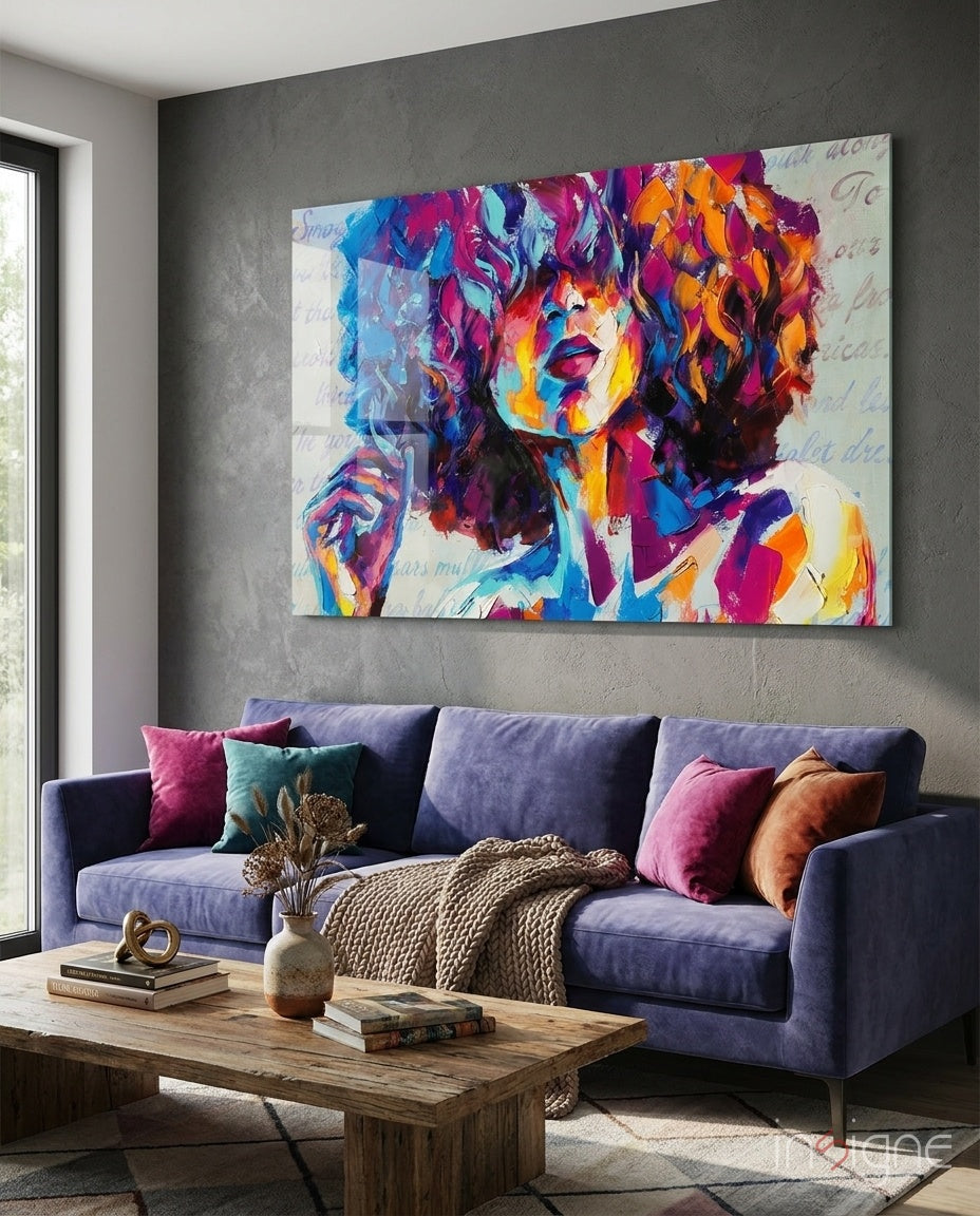 Colorful abstract portrait glass wall art hanging above a purple sofa in a modern living room interior.