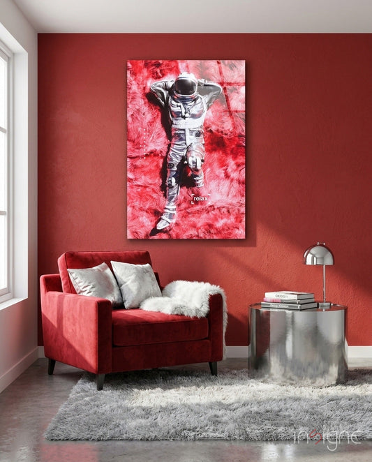 Red and pink toned astronaut canvas art displayed above a crimson velvet chair in a modern living room interior.