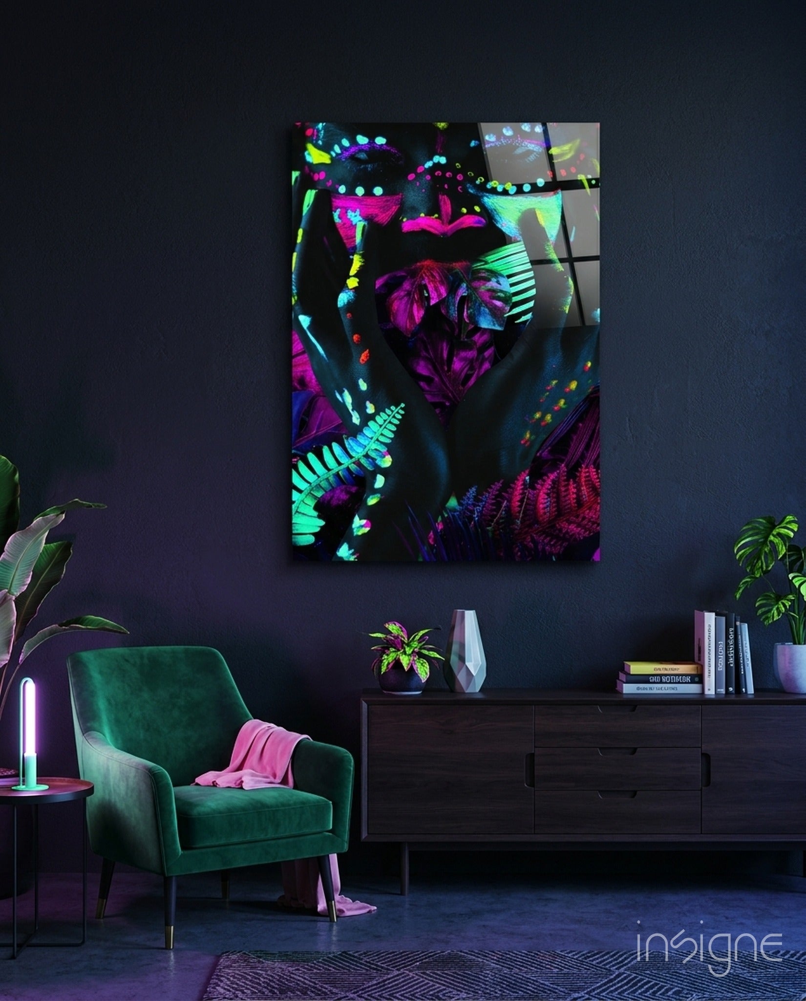 Neon Glances glass art panel displaying vibrant magenta, cyan, and yellow fluorescent botanical and geometric patterns hung above a dark dresser in a modern interior.