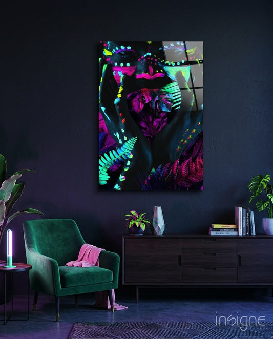 Neon Glances glass art panel displaying vibrant magenta, cyan, and yellow fluorescent botanical and geometric patterns hung above a dark dresser in a modern interior.