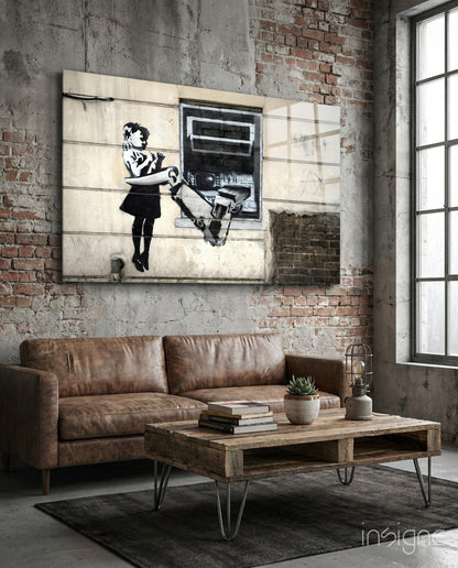 Industrial loft interior with brown leather sofa, wooden table, and black-and-white stencil street art on concrete wall.