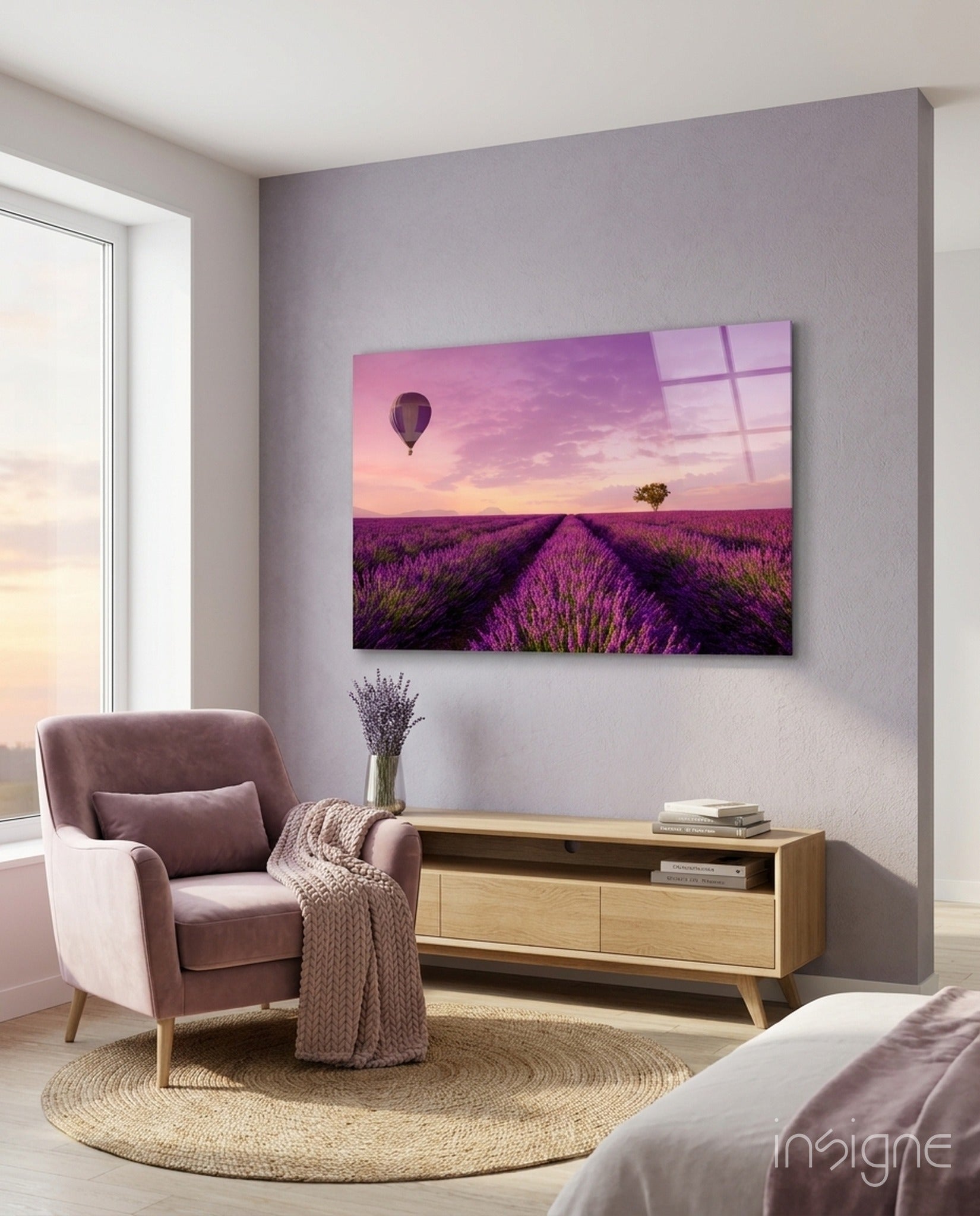 Glass art print of purple lavender field with hot air balloon and tree at sunset, displayed on bedroom wall above wooden console table.