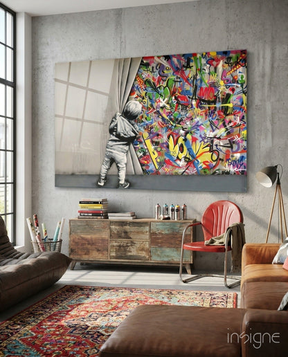 Behind the Curtain Glass Art displayed on concrete wall above wooden dresser in modern living room with colorful graffiti and child figure.