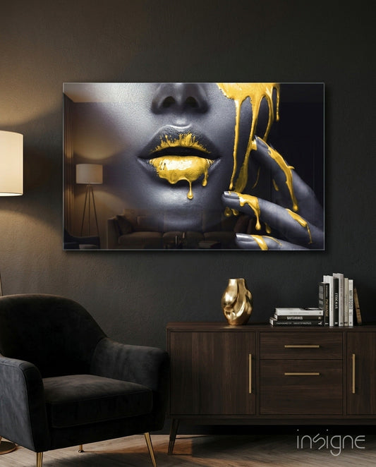 Yellow Lips Glass Wall Art displayed above a dark wooden cabinet in a modern living room setting with black chair and gold accents.
