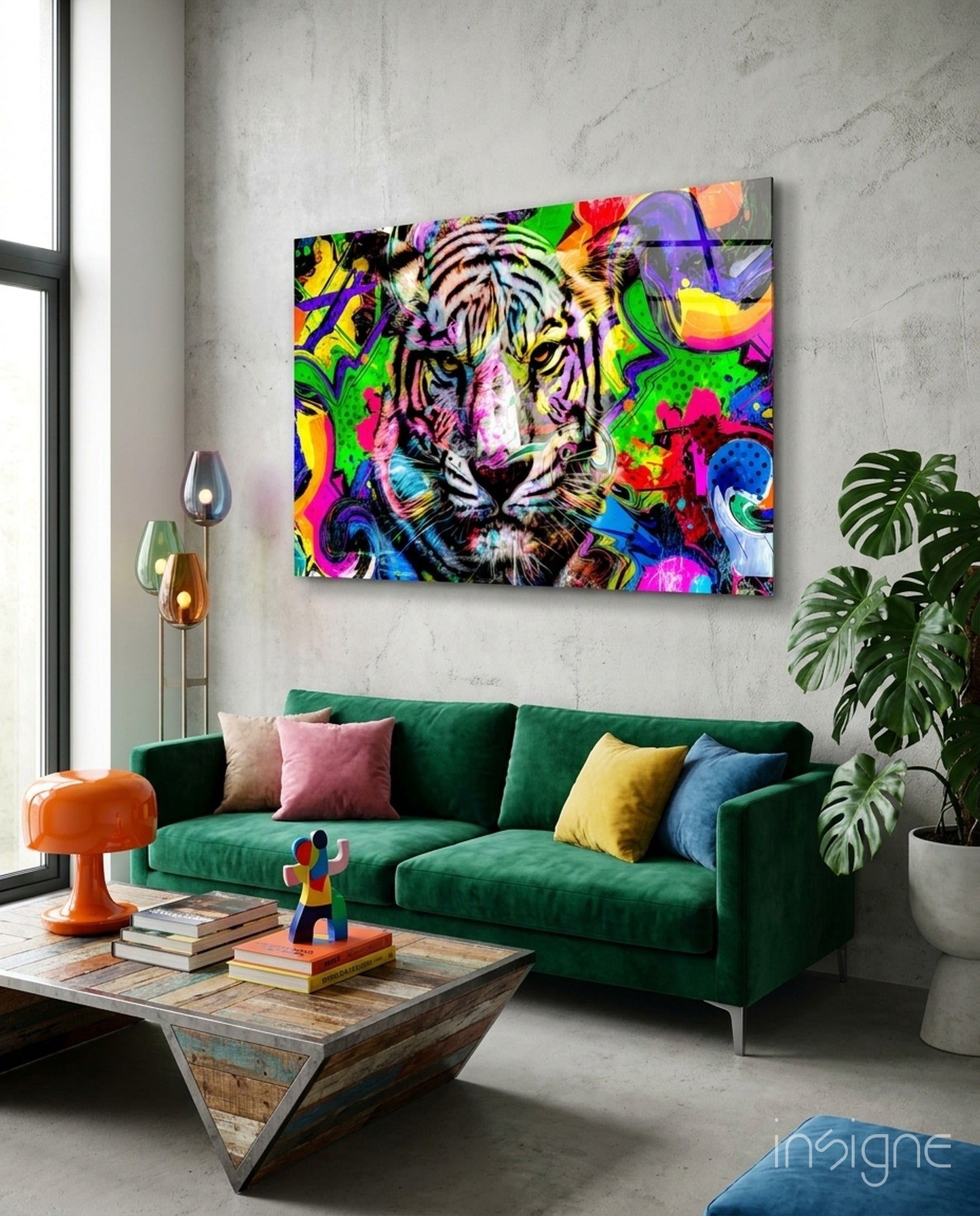 Vibrant multicolored glass tiger artwork displayed above green sofa in modern living room interior.