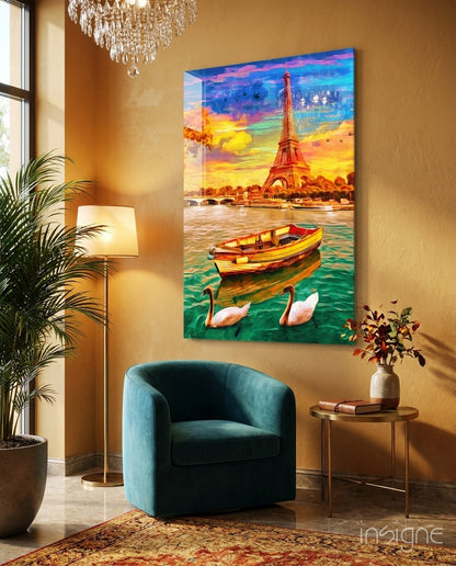 Colorful glass wall art depicting Eiffel Tower, boat, and swans displayed in warm-toned interior with blue chair and plants.