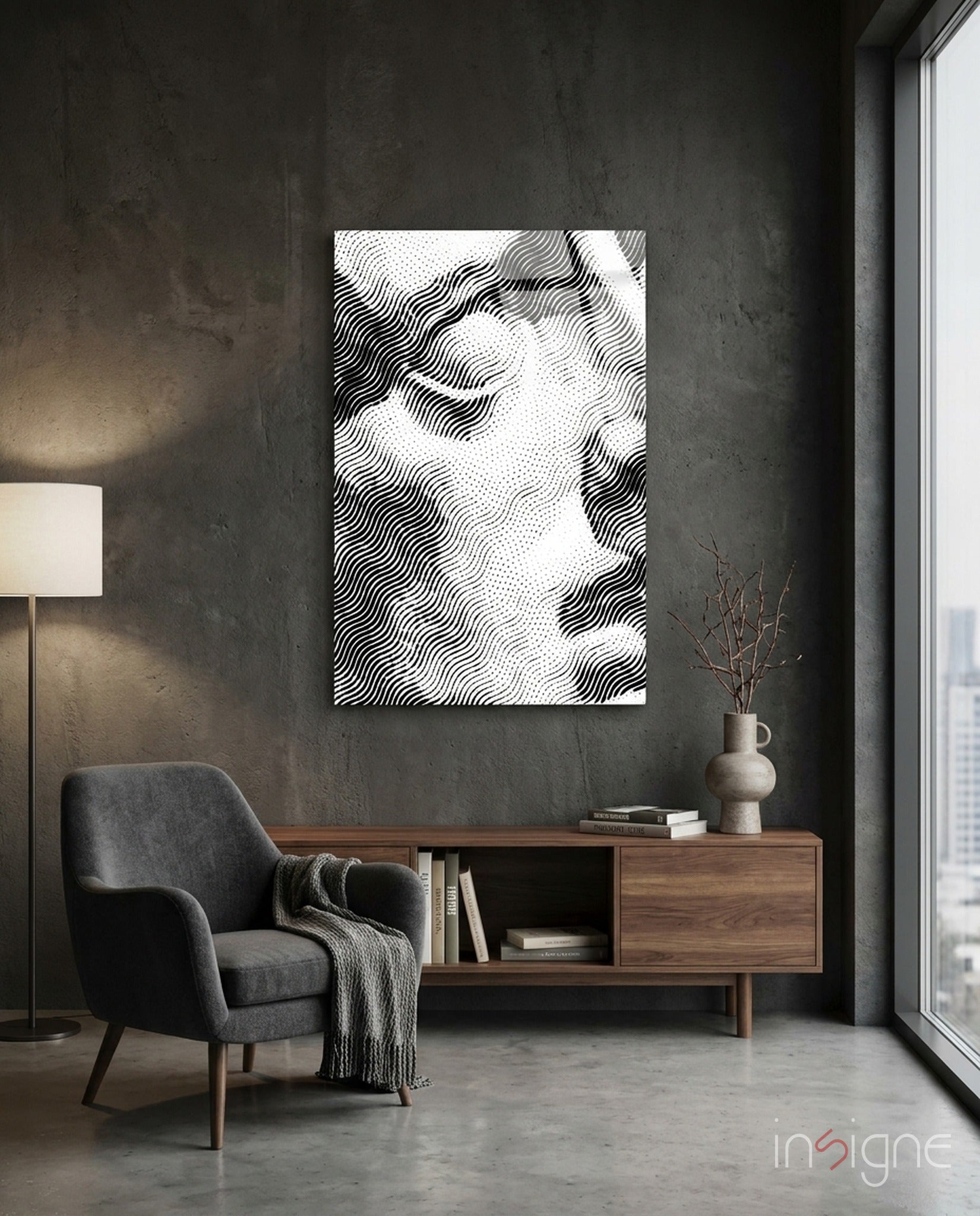 Black and white wavy line abstract canvas hanging above wooden credenza in minimalist concrete interior space.