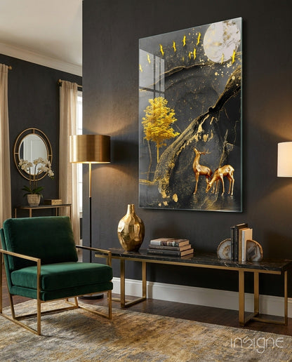 Golden tree and gazelles glass wall art displaying dark background with gold accents, mounted above black console table in modern living room setting.