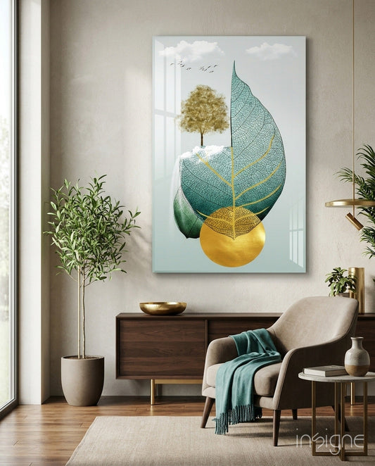 Modern living room displaying teal and gold leaf glass wall art above wooden dresser with potted plant and cream chair.