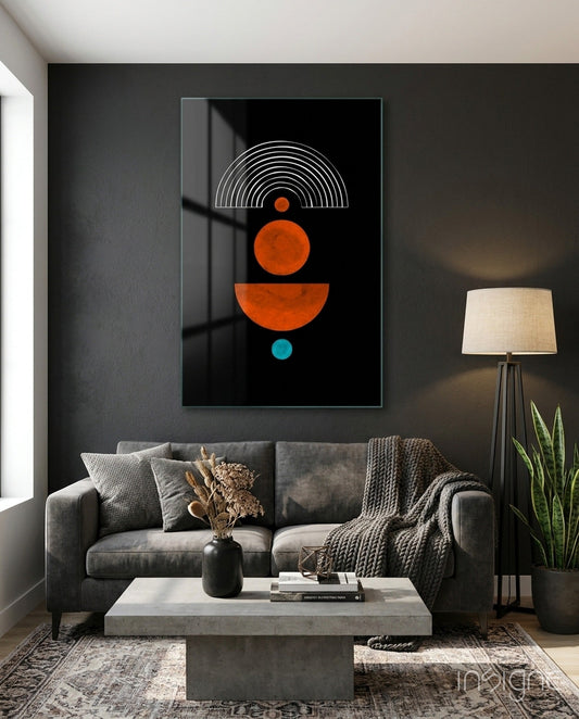 Orange and teal geometric glass wall art displayed above gray sofa in modern living room interior.
