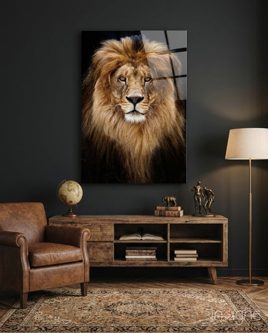 Glass wall art featuring a lion's portrait with golden mane displayed above wooden furniture in a styled interior room.