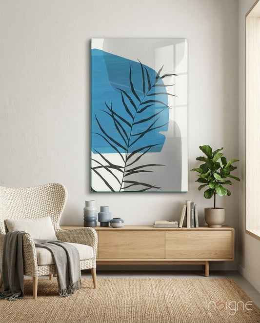 Autumn Blue Glass Wall Art displayed above a wooden dresser in a minimalist interior with cream chair and potted plant.