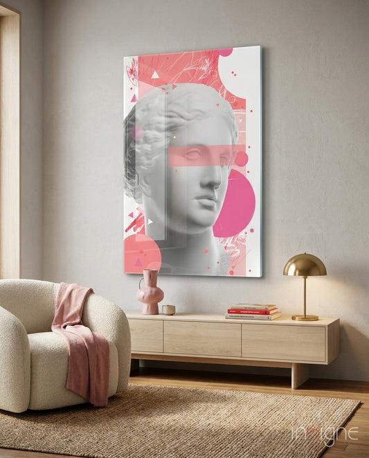 Modern living room interior featuring pink geometric Venus bust glass art panel displayed above light wood dresser with brass lamp and books.