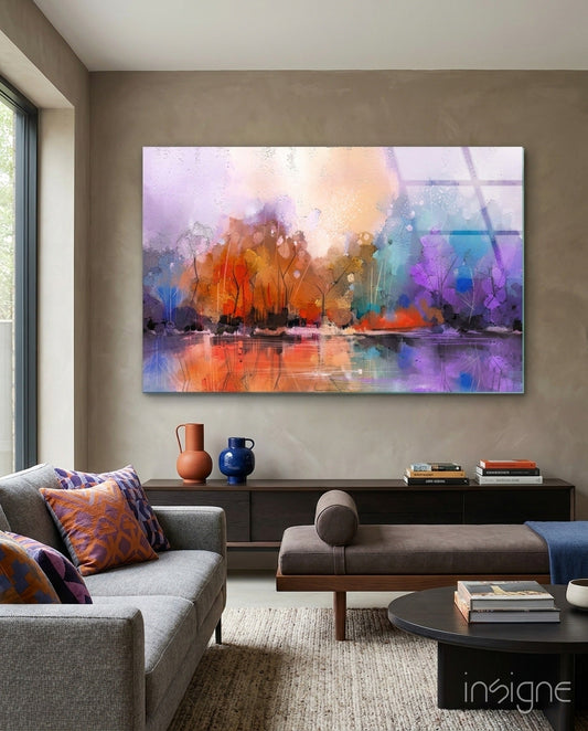 Colorful abstract landscape glass art with orange, purple, and blue tones displayed above a dark console table in a modern living room.
