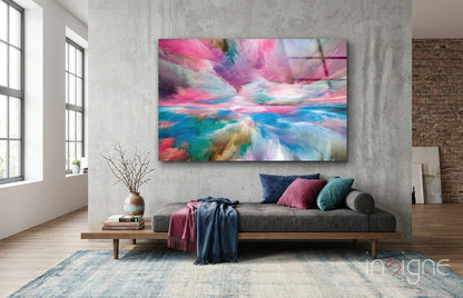 Modern living room with gray sofa displaying colorful abstract glass art featuring pink, blue, and turquoise clouds above.