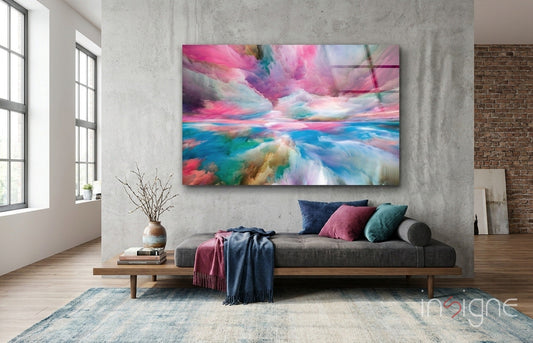 Modern living room with gray sofa displaying colorful abstract glass art featuring pink, blue, and turquoise clouds above.